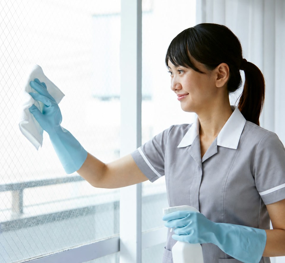 AI-edited demonstration photo of a house cleaner wiping a window